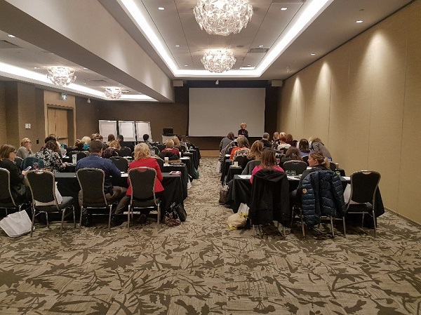 Photo of Linda Baker speaking during the workshop with participants watching